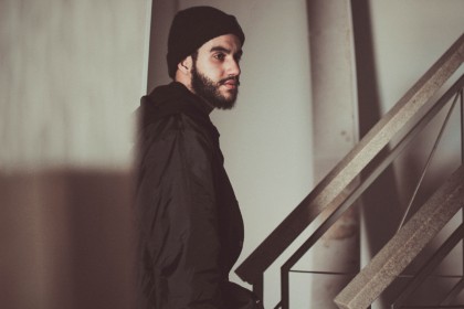 Urban young man in beard and black jacket