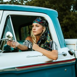 Beautiful and bold girl in a pickup truck