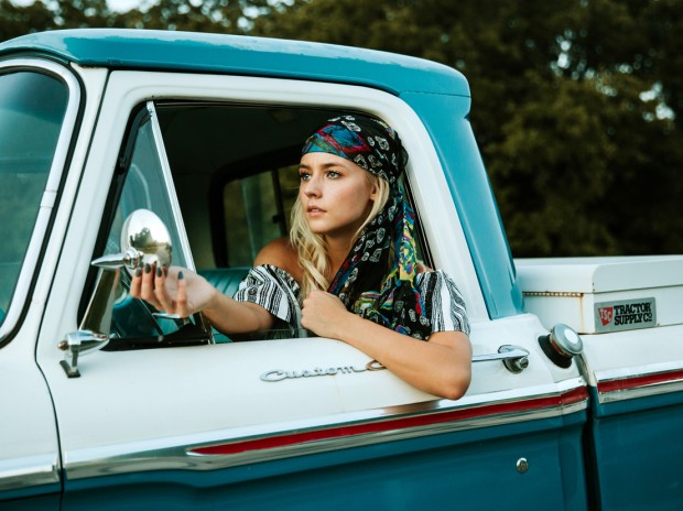 Beautiful and bold girl in a pickup truck